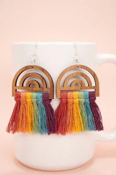 the rainbow tasseled earrings are made from wood and have wooden hoops on them