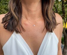 "A simple tiny white moonstone briolette stone suspended from a delicate gold filled or sterling silver chain. Perfect for adding a touch of shine to any layered ensemble. The stone is a tiny 7mm and a beautiful iridescent color. It matches everything! Shown here in 17\" length. Also available in many other gemstone options as shown in the photo. Please see our charm necklace section for the other gemstone options. *If you are unsure of the length you need, or would like to wear this item at dif Dainty White Crystal Necklace With Delicate Chain, Dainty Crystal Necklace With Delicate Chain And Round Pendant, Dainty Crystal Necklace With Round Pendant And Delicate Chain, Delicate White Crystal Necklace With Delicate Chain, Dainty White Moonstone Necklace, Dainty White Birthstone Necklace, White Crystal Necklace With Delicate Chain For Gifts, White Crystal Necklace With Delicate Chain As Gift, White Teardrop Solitaire Necklace Gift