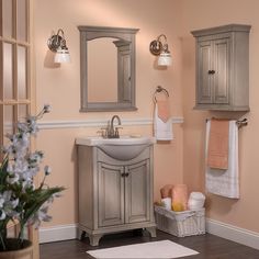 a bathroom with a sink, mirror and towel rack on the wall next to it