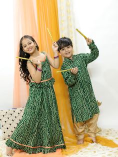 VASTRAMAY Green Bandhni Print Rayon Siblings Set Bollywood Style Traditional Wear With Batik Print For Navratri, Bollywood Style Batik Print Traditional Wear For Navratri, Green Bandhani Print Choli For Eid, Festive Multicolor Batik Traditional Wear, Festive Traditional Wear With Batik Print For Diwali, Bohemian Bandhani Print Sets For Festivals, Festive Batik Print Sets For Navratri, Bollywood Style Festival Sets With Traditional Patterns, Green Sharara For Diwali Festival