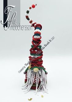 a christmas tree made out of beads and tassels on a white background with the title