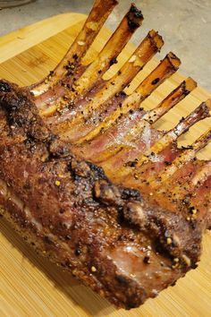 a large piece of meat sitting on top of a wooden cutting board