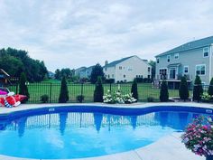 an empty swimming pool in front of some houses