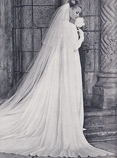 an old photo of a woman in a wedding dress