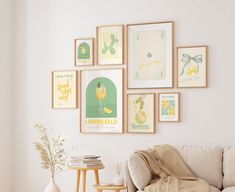 a living room filled with furniture and lots of framed pictures on the wall above it