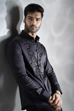 Black cotton shirt with black cutdana hand embroidered eagle.
Components: 1
Pattern: Hand embroidered
Type Of Work: Cutdana
Neckline: Collar
Sleeve Type: Full
Fabric: Cotton
Color: Black
Other Details: 
Note : Pant worn by the model is not for sale.
Occasion: Party - Aza Fashions Black Embroidered Formal Tops, Formal Black Embroidered Tops, Festive Traditional Shirt With Resham Embroidery, Black Embroidered Shirt For Formal Occasions, Festive Black Cotton Shirt, Formal Black Embroidered Shirt, Elegant Black Festive Shirt, Designer Embroidered Black Shirt, Designer Black Embroidered Shirt