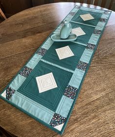 a teal table runner on a wooden table