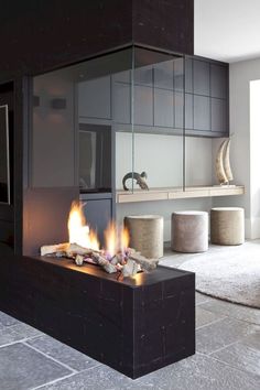 a modern fireplace in the middle of a living room