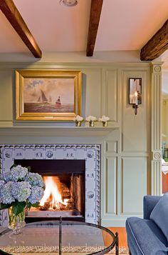 a living room filled with furniture and a fire place in the middle of a room