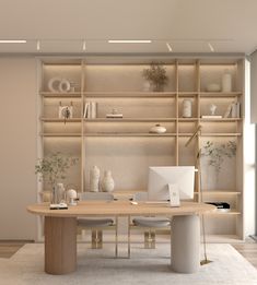 a room with a desk and shelves filled with vases, bookshelves and other items