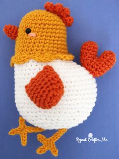 a crocheted stuffed chicken wearing a hat on top of it's head