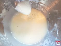 an egg being cooked in a pan with a spoon