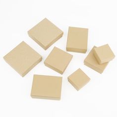 several pieces of cardboard sitting next to each other on a white surface with one piece missing