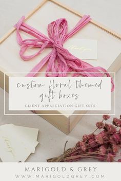 a box with pink ribbon tied to it and the words custom floral themed gift boxes