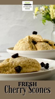 fresh cherry scones on white plates with flowers in the backgroung and text overlay that reads, fresh cherry scones