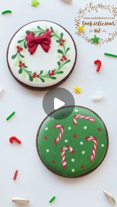 two decorated cookies sitting on top of a table