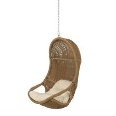 a brown hanging chair with white cushions