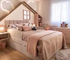 a child's bedroom with white walls and wooden flooring is decorated in neutral tones