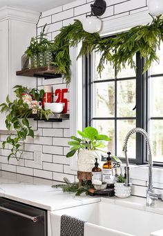 the kitchen is decorated for christmas with greenery