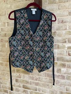 "🎳best rainbow tapestry black vest  Functioning buttons up front  Ties on side 🎳label: White Stag Tag size: large  Care: machine wash  Content: cotton / polyester/ other mix  Care: machine wash  Bust:42\" total  Waist:40\" total  Hip:42\" total  Length:24\" longest in front, 19\" in back  🎳I did hand wash and iron with a cool iron on back of vest.  I will try the prescribed \"dryer/ remove promptly\" to see if that helps the deeper wrinkles. Update soon?" 90s Vest, Plus Size Vintage Clothing, Rainbow Tapestry, White Stag, Vintage Vest, Plus Size Vintage, Black Vest, Vest Outfits, Boho Bohemian