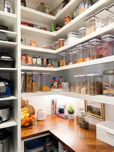 an organized pantry with lots of food and containers on the shelves, including fruits and vegetables