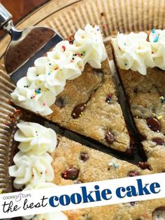 a chocolate chip cookie cake with white frosting and sprinkles