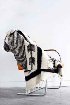 Queen sized ecru wool blanket with thin horizontal black stripes throughout the body and black arrow motif at both ends draped over a chair Black Blanket, Blanket Black, Couch Throws, Handmade Blanket, Weighted Blanket, Queen Size Bedding, Hand Loom, Wool Blanket, Guatemala