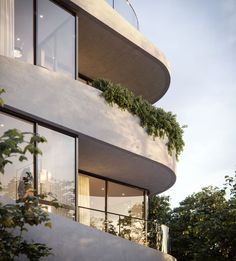 an apartment building with plants growing on the balconies