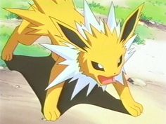 the pikachu is standing on its hind legs in front of some grass and dirt