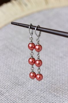 Unique pearl earrings with bright red-pink high quality czech glass pearl coated 8 mm beads, tiny stainless steel beads-separators, steel jumping ringa and stainless steel lever back earring hooks. Earring hooks are from nickel free and lead free metal. The total lenght of earrings is about 65 mm including earring hooks. Perfect jewelry for everyday wear and a great gift! Other earrings of my shop you can see here: https://www.etsy.com/shop/NaTavelli?section_id=13757927 Thanks for visit! Red Dangle Pearl Earrings For Jewelry Making, Red Pearl Dangle Jewelry, Red Dangle Pearl Earrings, Red Pearl Earrings As A Gift, Red Hypoallergenic Round Bead Earrings, Red Pearl Dangle Earrings, Unique Pearl Earrings, Red Pearl, Beaded Jewellery