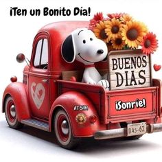 a red truck with a snoopy dog in the back and sunflowers on top