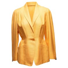 Vintage yellow silk blazer by Thierry Mugler. Circa 1988. Shawl collar. Dual hip pockets. Single front button closure. 35" bust, 15.5" shoulder width, 24" sleeve length, 26.5" length.