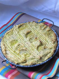 a pie sitting on top of a colorful table cloth