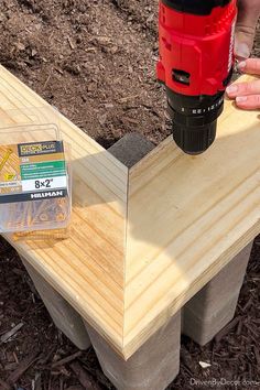 a person using a drill to attach a piece of wood on top of a bench