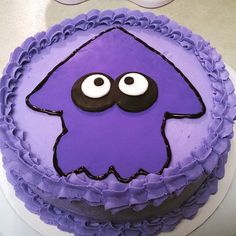 a purple cake decorated with an image of a monster