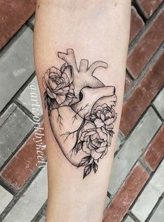 a black and white heart tattoo with roses