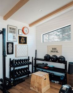 a home gym with equipment and posters on the wall