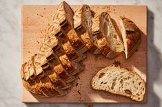 sliced bread sitting on top of a wooden cutting board