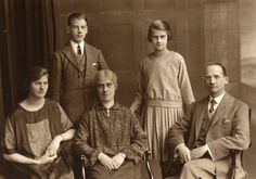 an old black and white photo of a family posing for a photograph in the early 1900's