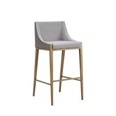 an upholstered bar stool in grey fabric with gold legs and backrests