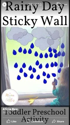 a toddler sitting in front of a window with rain drops on it and the words rainy day sticky wall