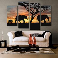 an elephant family silhouetted against the sunset in this living room wall art painting print on canvas