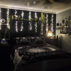 a bed room with a neatly made bed and lots of lights on the wall above it