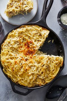 a skillet with some noodles in it and one piece missing from the pan on the side