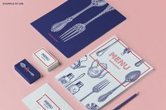 the stationery is laid out on top of each other, including a fork and knife