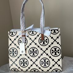 New Tory Burch, Never Used. Matte Leather With Brand Monogram In Relief And Patent Color. Each Side Of The Wallet Has A Different Color, Is Elegant, Sophisticated, Spacious, Has Many Pockets Inside And Is Medium Size. Designer Large Capacity White Shoulder Bag, Designer White Bags With Large Capacity, Luxury White Shoulder Bag With Large Capacity, Designer Large Capacity White Bags, White Luxury Large Capacity Shoulder Bag, Luxury White Large Capacity Shoulder Bag, Luxury Large Capacity White Shoulder Bag, Elegant Tan Bags With Large Capacity, Elegant Tan Bag With Large Capacity