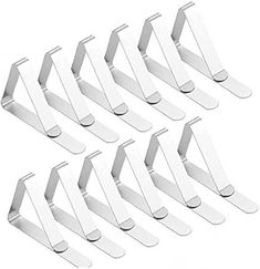 six white metal clothes hangers on a white background