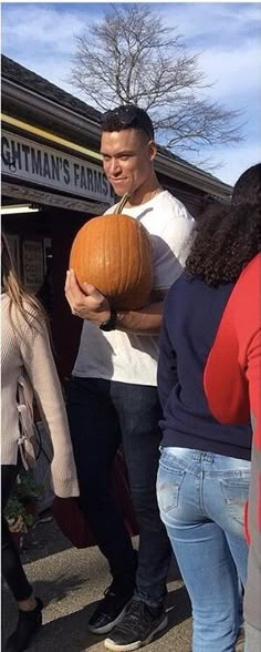 a man holding a pumpkin in his hands