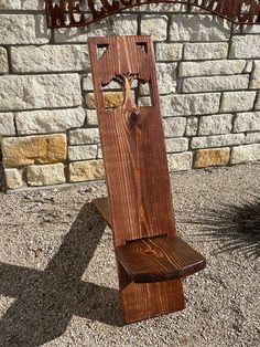 a wooden bench sitting in front of a brick wall