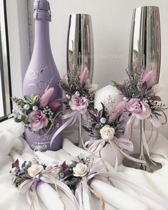 three vases with flowers and ribbons are sitting on the table next to each other